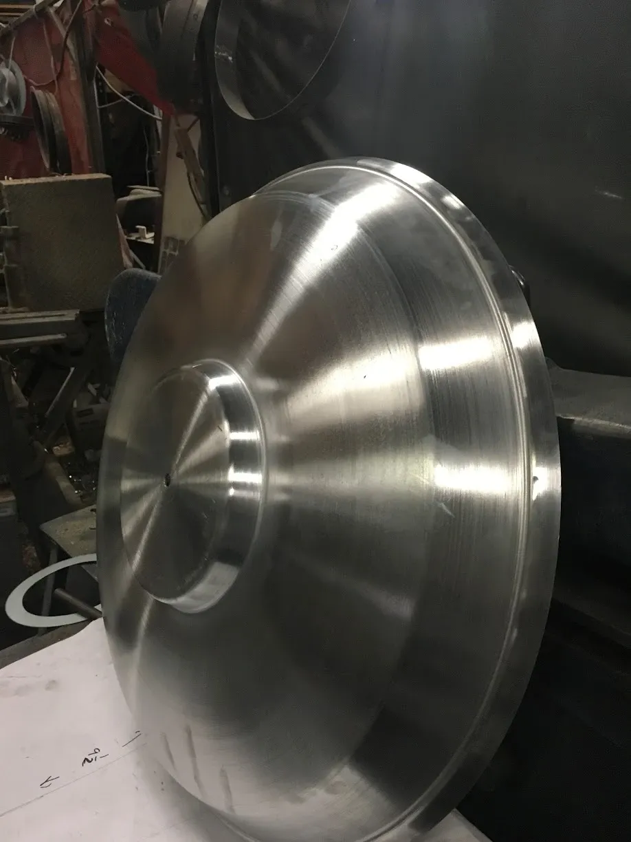 Close-up of a spun aluminum cover with a stepped center